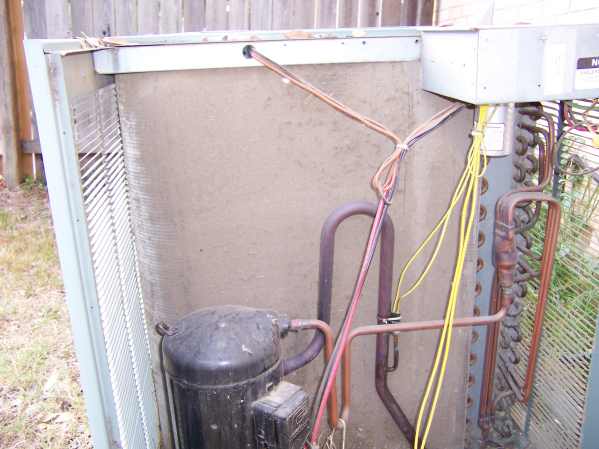 Photo of dirty condensor completely clogged with fine dirt.