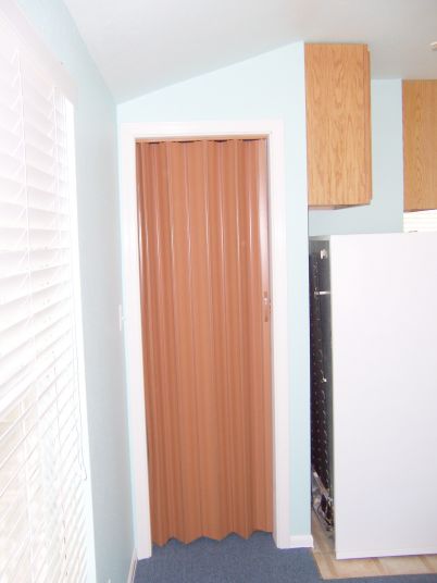 Since this is just a closet and a pocket door was impossible here, we used an accordion folding door to maximize wall space.