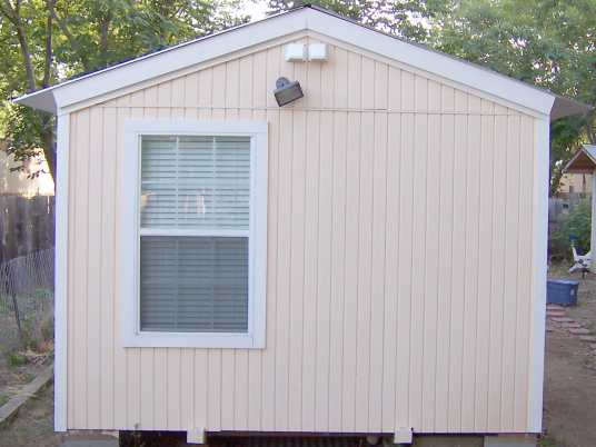 Has 4 inch on center grooved T-111 wood siding. Plywood siding is much better for portable buildings since it braces walls but is flexible enough not to break like cement siding.