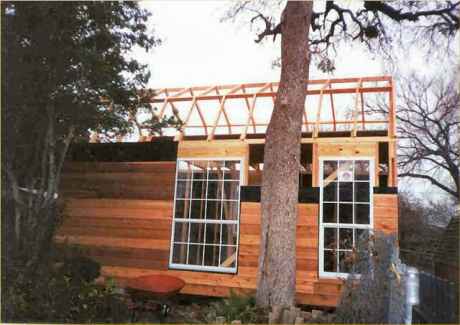 Windows installed before siding. Side view of roof trusses.